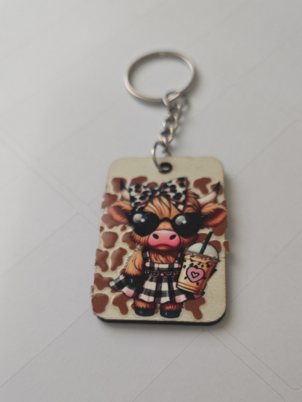 Handmade cowgirl cow keychain – Cute Western Cow‑Print Bag Charm. Key07